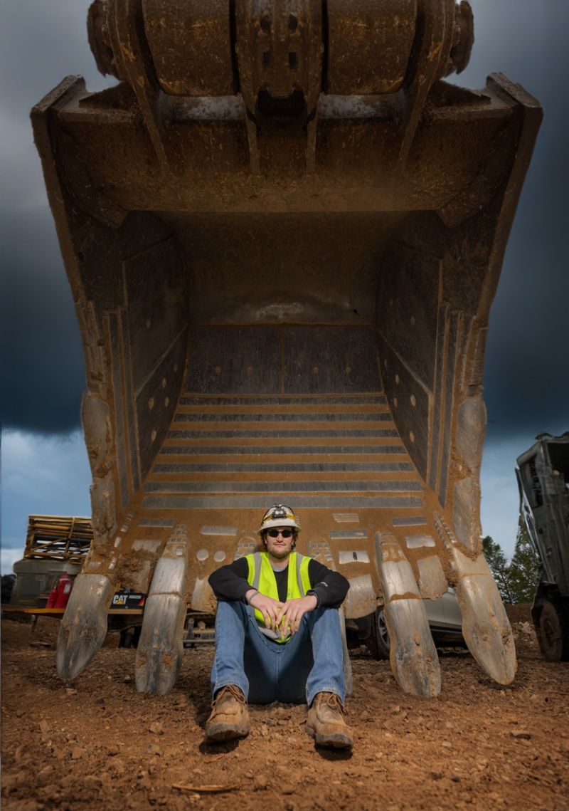 worker sitting on giant truck